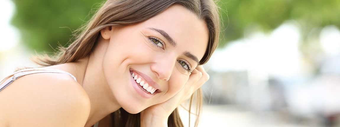 Woman smiling after seeing cosmetic dentist in Chula Vista
