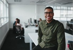 man smiling while in office