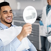 Man smiling at reflection in mirror