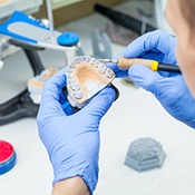 Man carving dentures