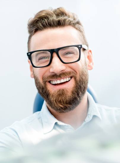 man smiling in treatment chair